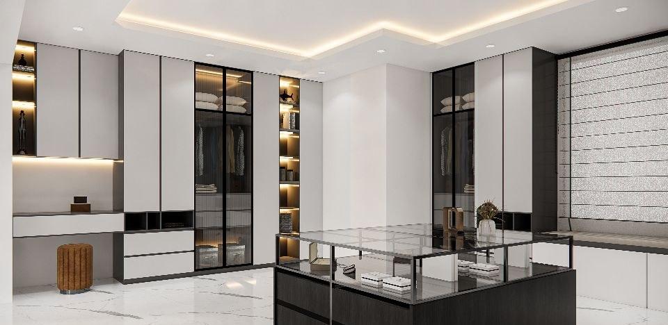 Dressing room design with a glass-topped display island, lit wardrobes and a built-in dressing desk